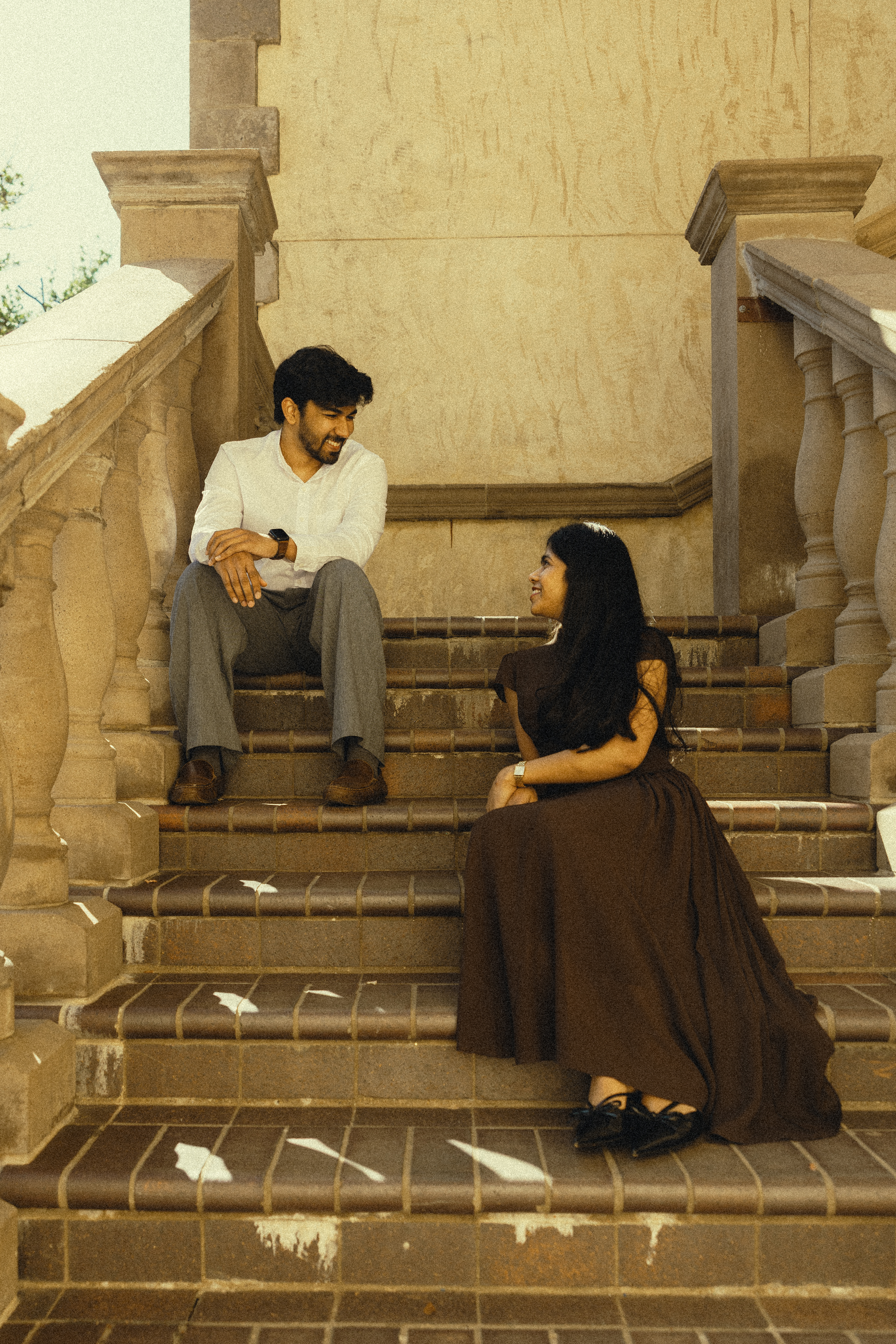 Durga and Akhil sitting on steps